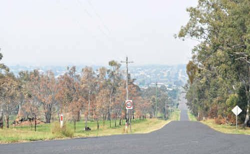 Looking down Rose St from the golf course, smoke hovers over the township of Warwick yesterday. Looking down Rose St from the golf course, smoke hovers over the township of Warwick yesterday.